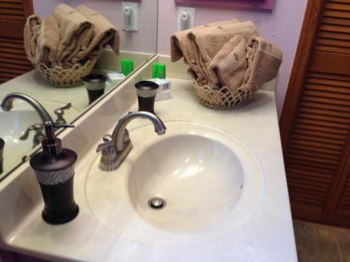 a sink in a bathroom with towels on a counter at Walk to Indian Rocks Beach Exclusive Use of Hot Tub, Pool, BBQ,with Privacy in Largo
