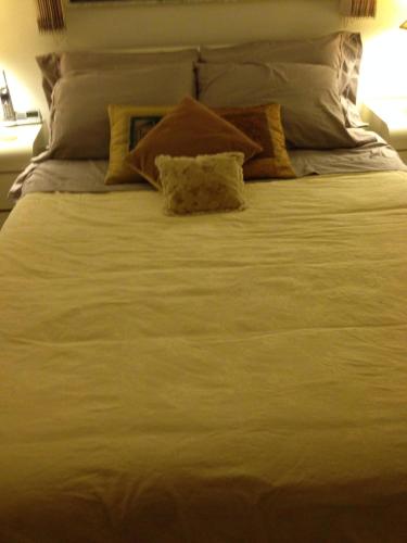 a large white bed with two pillows on it at Walk to Indian Rocks Beach Exclusive Use of Hot Tub, Pool, BBQ,with Privacy in Largo