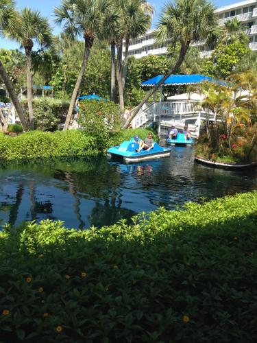 two people are riding in paddle boats on a river at Walk to Indian Rocks Beach Exclusive Use of Hot Tub, Pool, BBQ,with Privacy in Largo