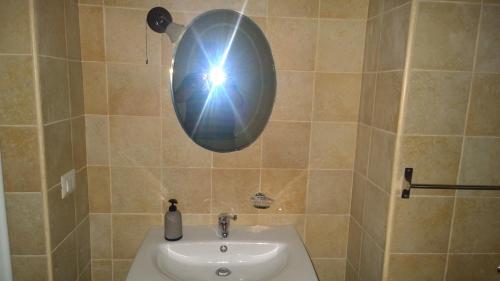 a person taking a picture of a bathroom sink at Donna Teresa in Mottola