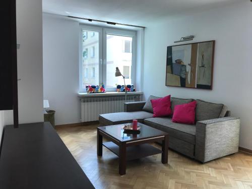 een woonkamer met een bank en een tafel bij Nina na Bielańskiej in Warschau