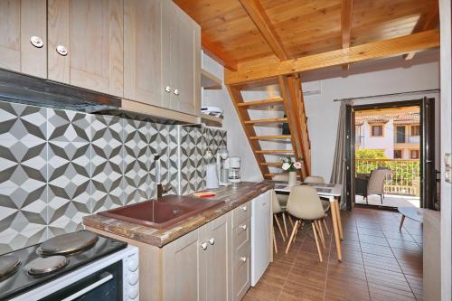 a kitchen with a sink and a stove at Smaragda Studios Skopelos in Skopelos Town