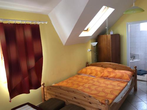 a bedroom with a bed in a room at Liget apartman in Balatonföldvár
