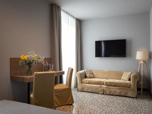 a living room with a couch and a table at HNN Luxury Suites in Genova