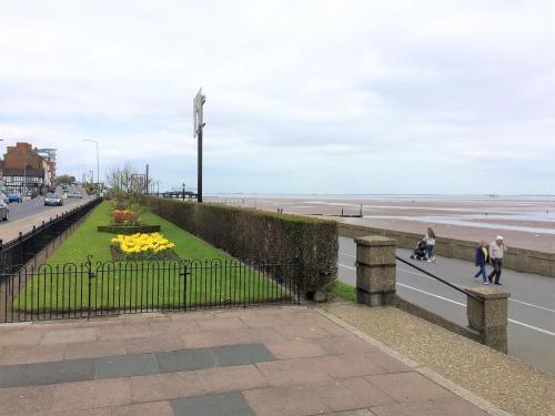 a group of people walking on a bridge near the beach at Lovely Sea Front House in Cleethorpes on Beachfront sleeps up-to 6 in Cleethorpes