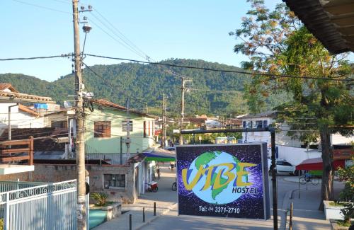 a sign on the side of a city street at Vibe Hostel Paraty in Paraty