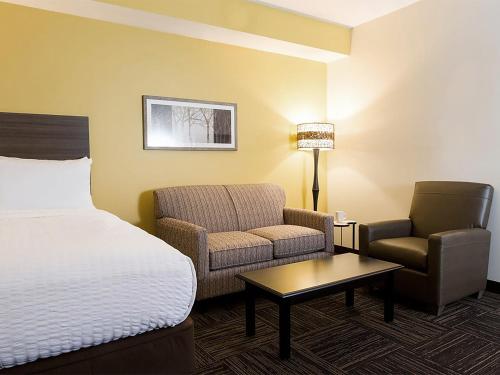 a hotel room with a bed and a chair at Extended Stay America Suites - Rock Hill in Rock Hill