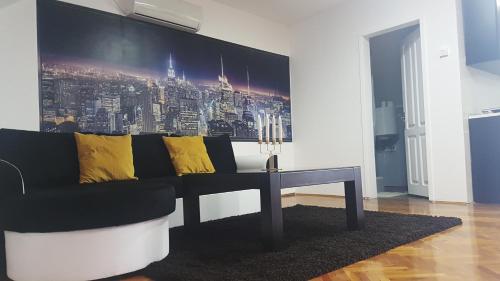 a living room with a couch and a table at Apartments & Pool Villa White House in Pančevo