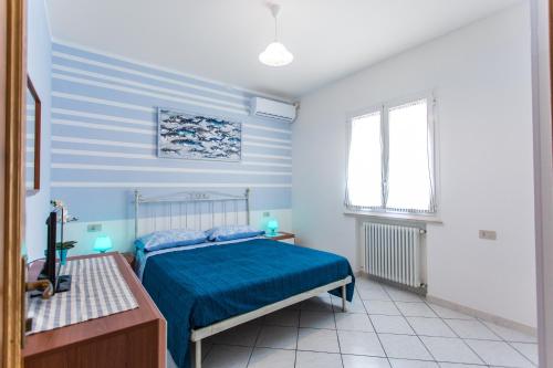 a bedroom with blue and white walls and a bed at Residence Kimba in Rimini
