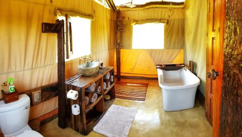 a small bathroom with a toilet and a sink at OuKlip Game Lodge in Klipdrift