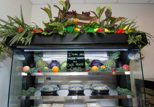 a display of fruits and vegetables on top of a refrigerator at The Barrymore Hotel Tampa Riverwalk in Tampa