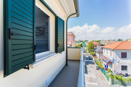 a window on a building with green shutters at Residence Kimba in Rimini