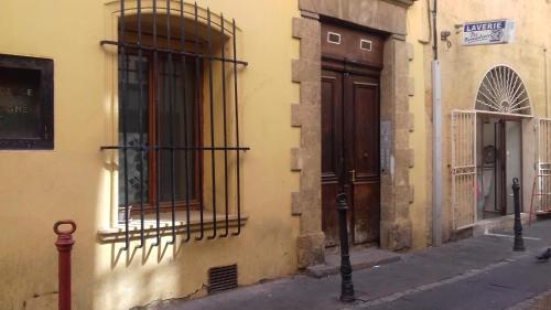 a building with bars on the side of a street at studio centre d Aix in Aix-en-Provence