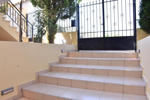 a set of stairs with a black gate at Keratea Apartment Athens Airport in Keratea