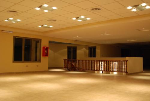 a large empty room with a staircase in the ceiling at Hotel Savoia Mendoza in Guaymallen