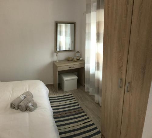a bedroom with a teddy bear sitting on a bed at BIO Garden Stonehouse in Gonia