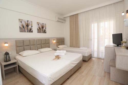 Posteľ alebo postele v izbe v ubytovaní Sun Hotel