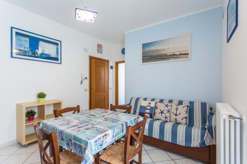 a living room with a table and a couch at Residence Kimba in Rimini