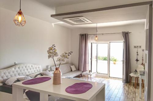 a living room with a white couch and a table at Studio Apartment "Brigita",free parking in Rijeka