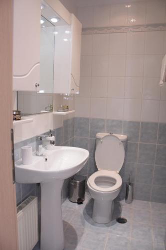 a bathroom with a toilet and a sink at Keratea Apartment Athens Airport in Keratea