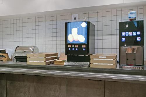 a check in counter with a pay phone and boxes at First Hotel Brommaplan in Stockholm