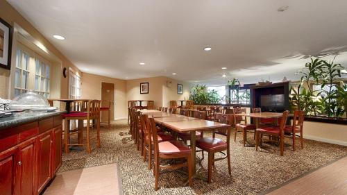 a dining room with wooden tables and chairs at Best Western Rockland in Rockland