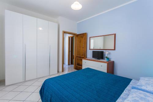 a bedroom with a bed and a desk with a television at Residence Kimba in Rimini