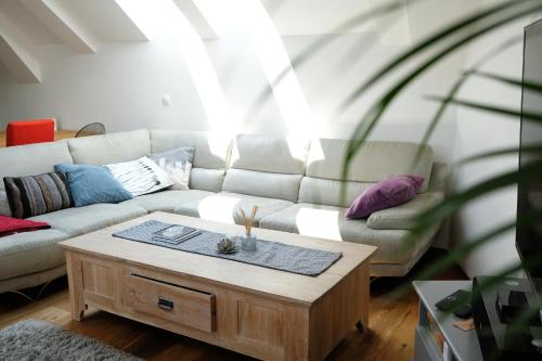 a living room with a couch and a coffee table at Happy River House in Kamna Gorica