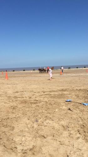 a group of people standing on a beach at Pine drive in Mablethorpe