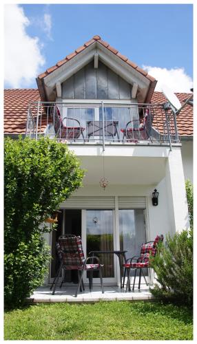 two chairs sitting on the porch of a house at DOUBLE Two Lodge in Kappel-Grafenhausen