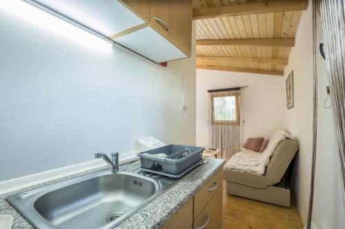 a kitchen with a sink in a tiny house at Eco Holiday Home Lavanda in Funtana