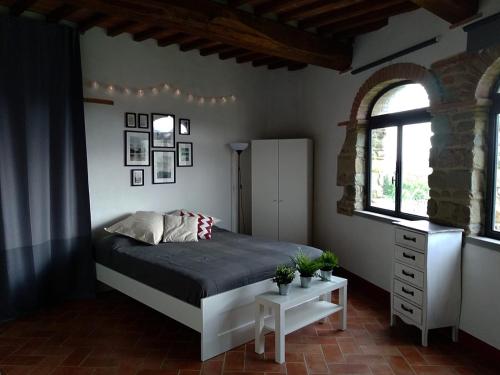 a bedroom with a bed and two windows at Da Vinci Sweet Home in Castiglion Fibocchi