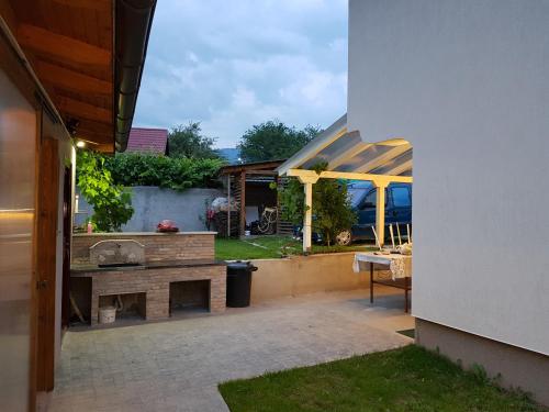 a patio with a bench and a table in a yard at Lakeview rest Home in Konjic