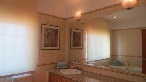 a bathroom with a sink and a mirror at A Casa do Lagar in Azeitao