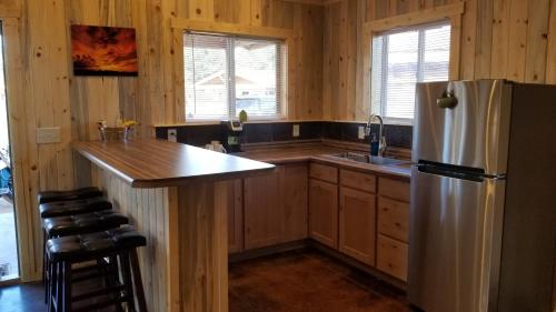 a kitchen with a stainless steel refrigerator and a counter at Bluff Gardens in Bluff