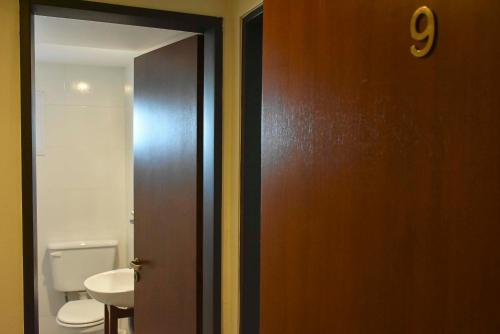 an open door to a bathroom with a toilet at Hotel Playa in Comodoro Rivadavia