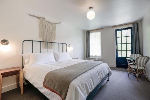 a bedroom with a large bed and a table and chairs at Surf Hotel & Chateau in Buena Vista