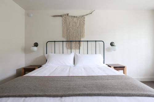 a bedroom with a bed with a cross on the wall at Surf Hotel & Chateau in Buena Vista