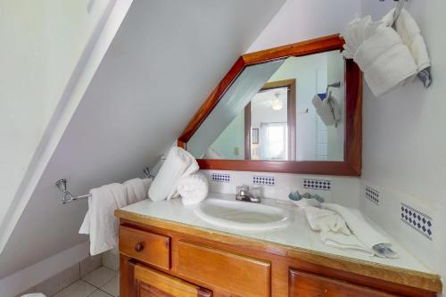 a bathroom with a sink and a mirror at Palm @ Caribe Island in San Pedro