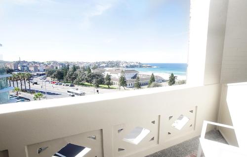 a room with a window with a view of the ocean at Hotel Bondi in Sydney