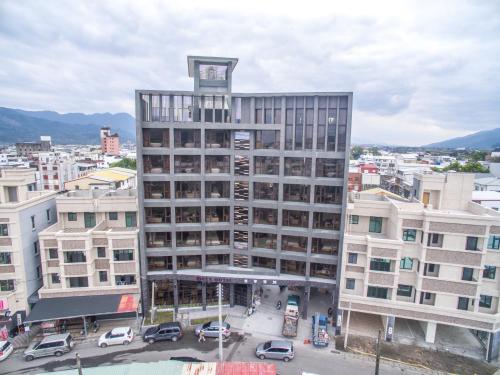 a tall building with a clock on top of it at KET Hotel in Yuli