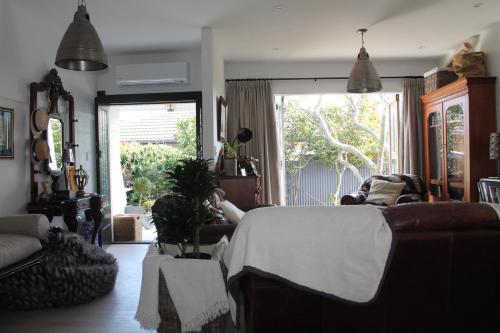 a living room with a bed and a couch at Beautiful Bungalow CBD in Blenheim