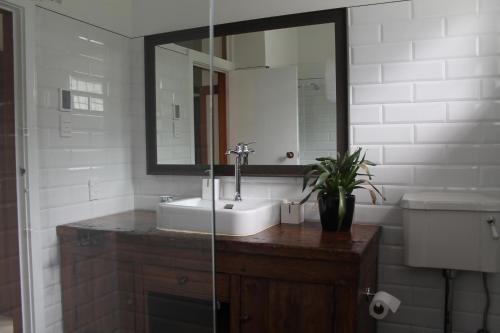 a bathroom with a sink and a mirror at Beautiful Bungalow CBD in Blenheim