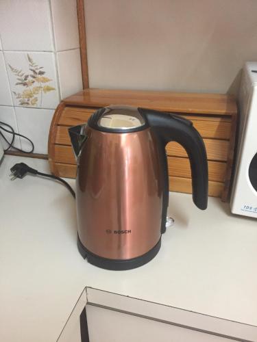 a tea kettle sitting on top of a kitchen counter at Artemis House in Limassol