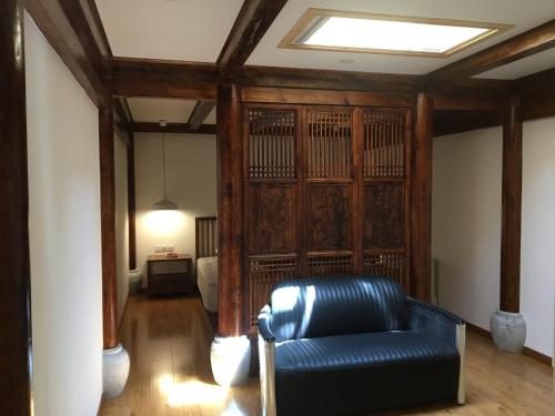 a living room with a couch and a bed at Beijing Downtown Travelotel in Beijing