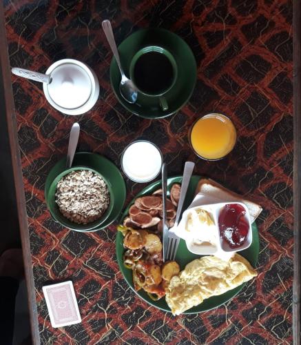 a table with a plate of breakfast food and a cup of coffee at Hotel Nagarkot Holiday Inn in Nagarkot