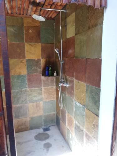 a bathroom with a shower with colorful tiles at Coco Country Homes in Melaka
