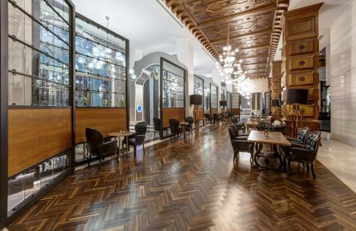 a lobby with tables and chairs and windows at Granada Luxury Belek - Family Kids Concept in Belek