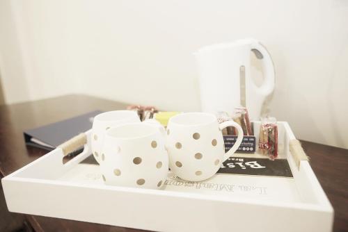 two mugs sitting on top of a drawer at Hotel Bondi in Sydney