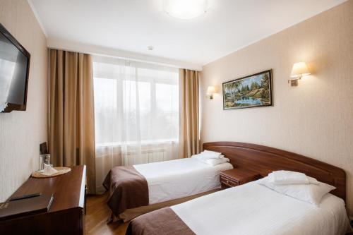 Кровать или кровати в номере Гостиница Урал